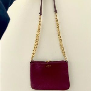 Unworn Lodis brand italian leather maroon bag with gold detailing